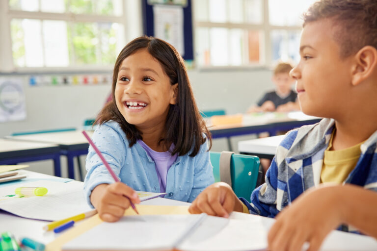 Indian child working together with friend for a group task