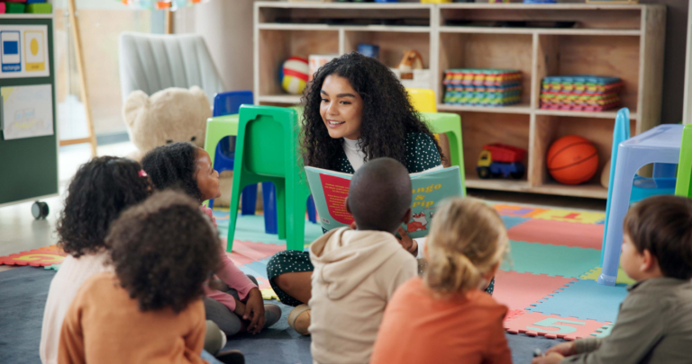 Reading, education and teacher with children in classroom for learning, books and creative